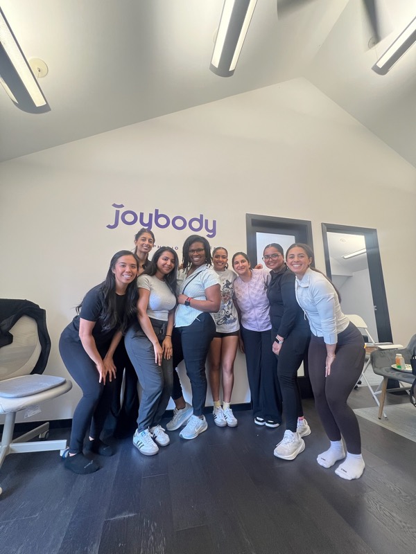 The Joybody team laughing together in the studio